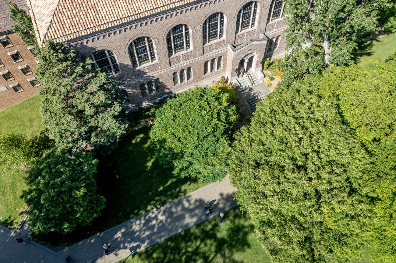 Birds eye view of the front of Wilson Library surrounded by bright green trees